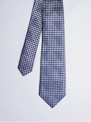 Cravate bleu marine avec motifs géométriques blancs