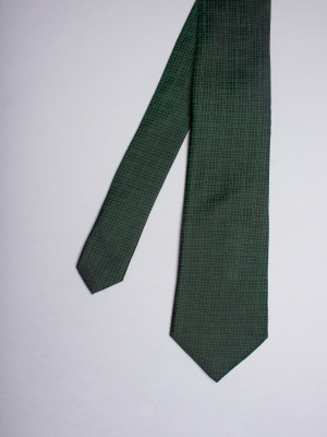 Black tie with green checkered pattern