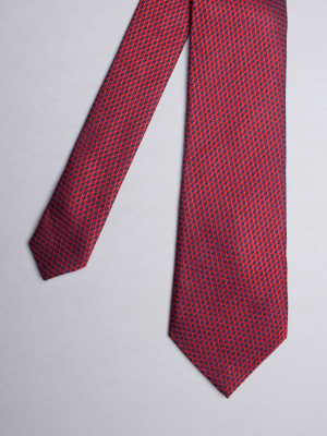 Red tie with blue hexagons patterns