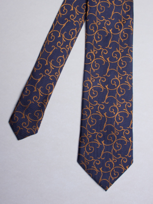 Blue tie with yellow arabesques patterns