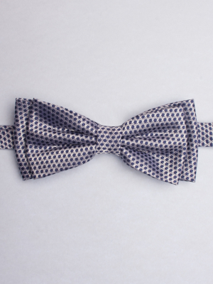 Grey bow tie with blue hexagons patterns