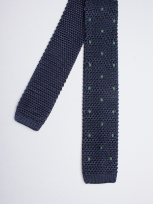 Navy blue knitted silk tie with green dots